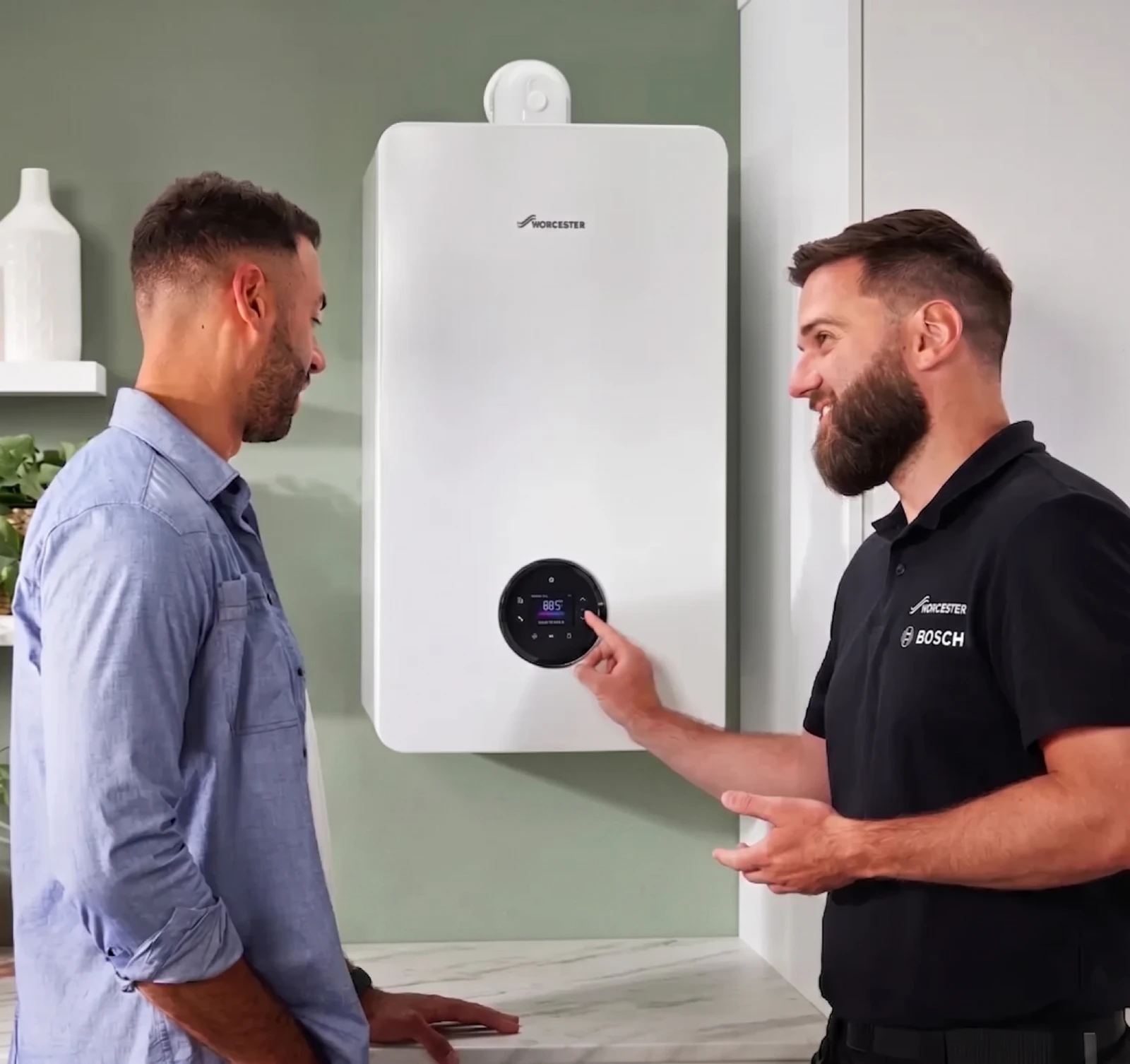 Gas Safe engineer showing a customer the controls on a new boiler in Godalming