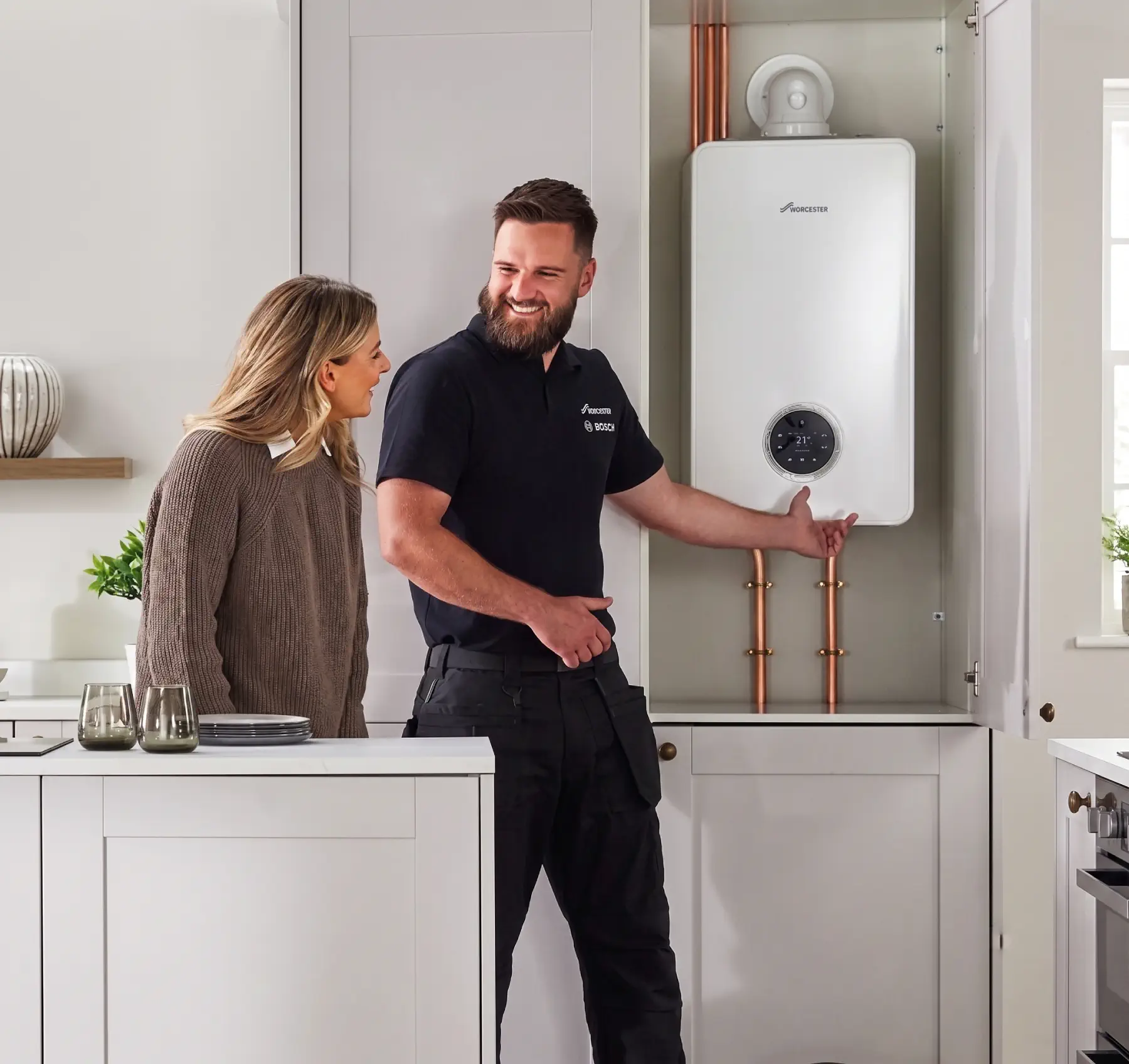 Engineer talking a homeowner through a newly fitted combi boiler in Send