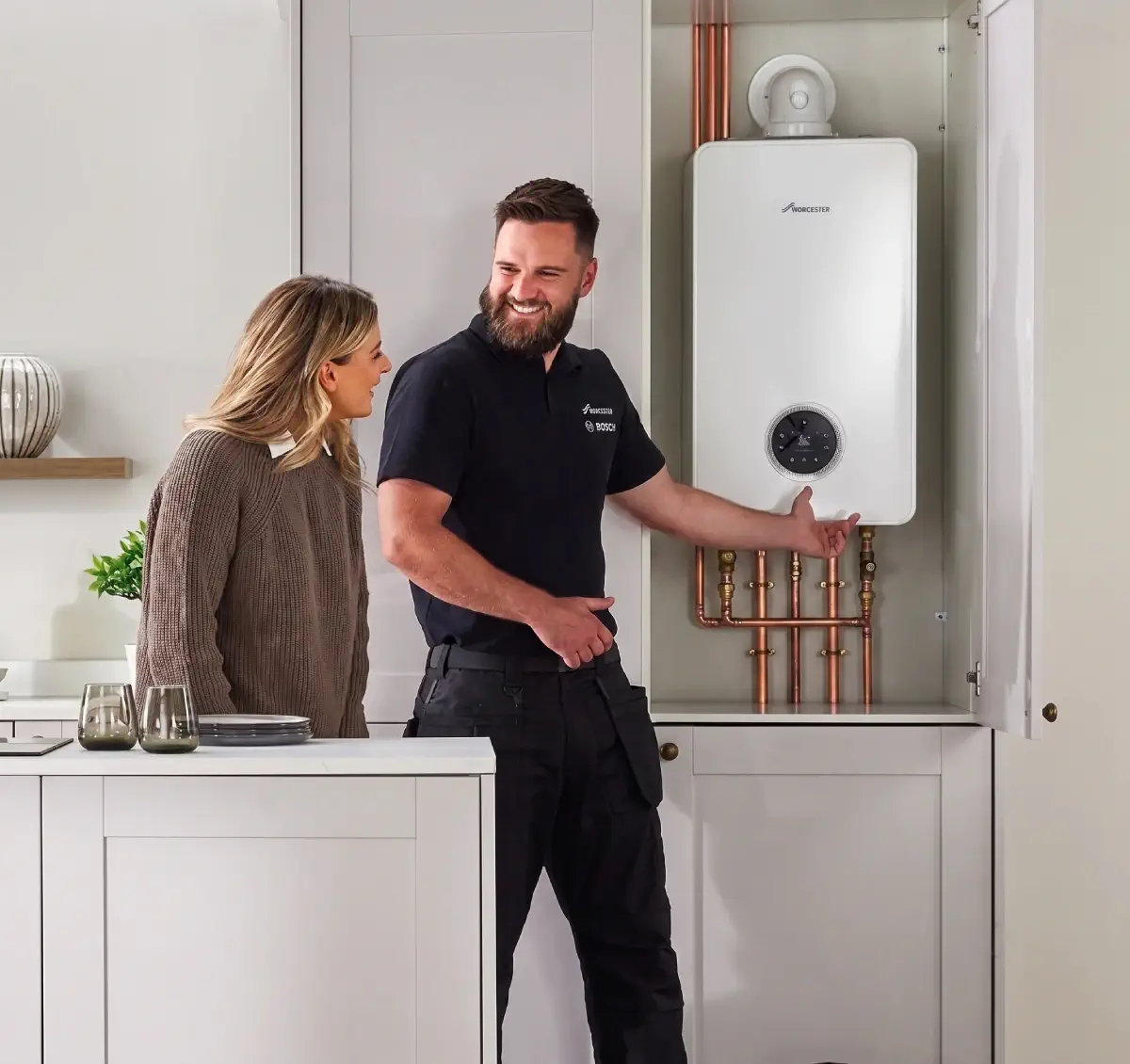 Engineer explaining a replacement boiler to a homeowner in Send